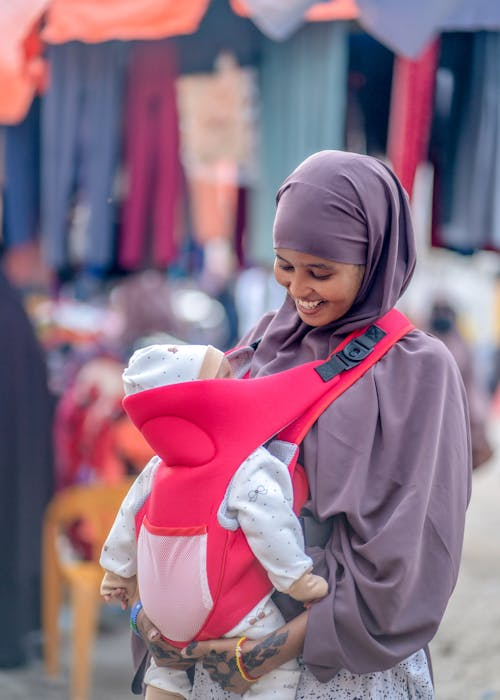 Smiling Somali mother with her baby — the heart of BitSom