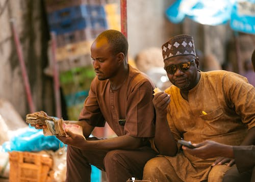 Men counting cash at market